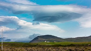 4k video time lapse with a magnificent lenticular cloud forming above a mountains peak.