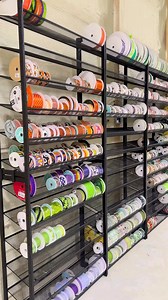 Who else thought Meghan would have gotten a little farther with organizing all the ribbon?? Who else has racks of ribbon?? This was only about 10 or so boxes... and we've got a 100 more to go 😅 | DecoExchange