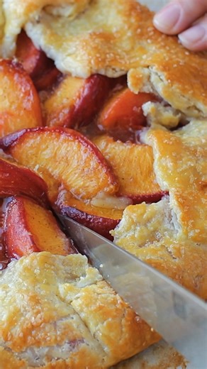 This Peach Galette recipe is perfect in every way, with a buttery, flaky crust and juicy cinnamon-dusted peaches. 🍑 RECIPE: https://natashaskitchen.com/peach-galette-recipe/ | NatashasKitchen.com