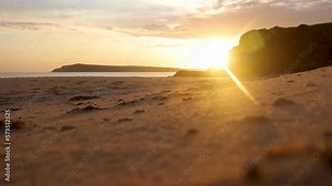 Beautiful shot focus racking from shells and sand to a sunset in the distance on the coast.