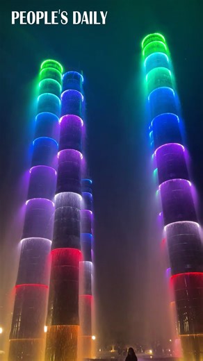 50K views · 1.1K reactions | Like bamboos drenched in water showers and lit with neon lights, these fountain towers dazzle onlookers in southwest China’s Chengdu. | People's Daily, China | Facebook