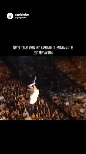 applejuice on Instagram: "😂😭 At the 2009 MTV Movie Awards, Sacha Baron Cohen -performing as his flamboyant character Brüno- orchestrated an elaborate aerial stunt where he descended from the ceiling on a wire harness, clad in angel wings and a jockstrap. The act culminated in Cohen "crashing" upside down onto Eminem, landing with his buttocks directly in the rapper's face. While the interaction appeared to be a genuine disaster that prompted Eminem and his entourage to storm out in a rage, it 