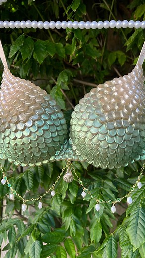 Beneath The Bay on Instagram: "🧚‍♀️✨ Say hello to “Iridesa” — the most fairycore mermaid bra I’ve ever made 💫🌿 Hand-piped using CT1 (because magic needs the right glue 😉), the scales shift from soft pearl to seafoam green. Finished with a delicate gold chain, fresh water pearls, and a little gold seashell charm, she’s giving forest nymph meets ocean queen 🌊👑 Perfect for festivals, photoshoots, mermaid events… or just those moments you want to feel otherworldly 🐚 Handle with love — she’s a