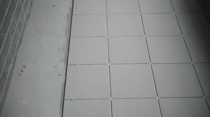 Floor tiles with spacers in installation process