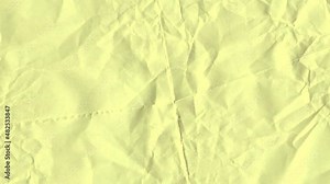 Video background, light yellow colored wrinkled paper texture background.