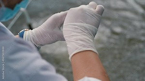 Water sample. Bacterial control of pool water. Checking the amount of algae, harmful substances and chemicals. Laboratory study of water from artificial reservoirs. Taking liquid into a test tube