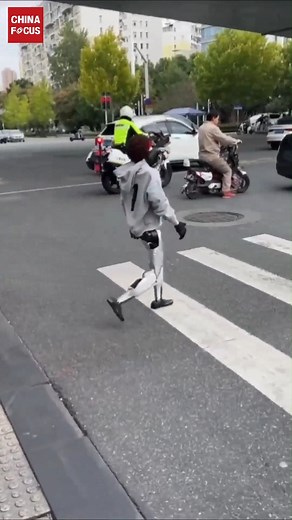 114K views · 1.8K reactions | Check it out! A humanoid robot wearing a hoodie was recently spotted crossing a street in Wuhan, Hubei Province. It even knows how to yield to pedestrians.藍 | China Focus | Facebook
