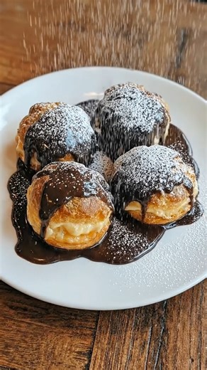 Authentic Italian Cream Puffs – Golden Choux Pastry with Luscious Vanilla Custard There’s nothing more elegant than biting into a freshly made Italian Cream Puff — that crisp, golden shell cracking open to reveal silky, velvety custard tucked inside. These bakery-style beauties are light yet indulgent, airy yet rich, and absolutely unforgettable. Whether you're hosting Sunday dinner or just craving something classic and impressive, this is the dessert that makes everyone pause mid-bite. Save thi