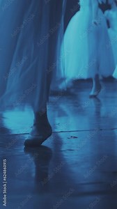 Synchronized dance of ballerinas in pointe shoes. on stage. a lot of pairs of legs in the frame. synchronous leg movements ballerin. Slow motion. Vertical format for the phone.