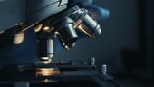 Scientist hands with microscope close-up shot in the laboratory