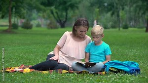 Teacher providing additional classes for junior pupil, individual tutoring