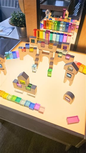 Rebecca Moore on Instagram: "We set up this provocation to inspire some light play this week. ✨ The light table brings our @playful.little.hearts acrylic blocks and wooden castle set to life, unlocking endless creativity and imagination! These would make an amazing gift for a little person in your life!  Use moore10 for a discount #gifted #InspiredPlay #CreativeBuilding #LightTableMagic"