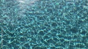 reflection and ripples in mosaic tiled swimming pool