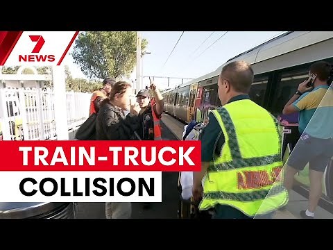 Train and truck collide at Brisbane level crossing | 7NEWS