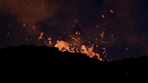 Premium stock video - Powerful volcano eruption with molten magma ejecting from crater at night
