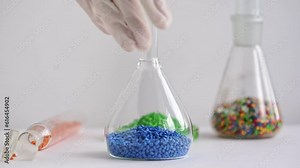 tubes in laboratory. Plastic factory laboratory. Glass flasks with colored dye in granules for plastics. polymer industry.