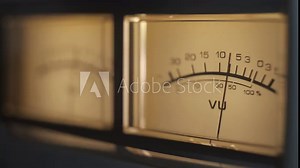 Audio signal levels monitoring audio console on classic sound amplifier. Close-up analog signal indicator with arrow