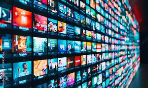 A vibrant display of multiple screens showcasing various colorful media content in a modern, tech-savvy environment.