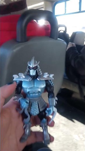 showing off my five-dollar shredder action figure I got