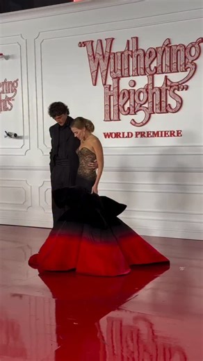 @MargotRobbie stepped out with @jacobelordi at the premiere of Wuthering Heights wearing a custom black-and-red strapless @schiaparelli gown with a lace corseted bodice and sculptural velvet skirt, styled by @andrewmukamal . Hot! Or Hmm..? 📸: @warnerbros / via Getty Images #MargotRobbieFBD #margotrobbie #margotrobbieStyle #fashionbombdaily #fbdaily BombStyle | Fashion Bomb Daily