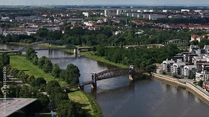 Telephoto shot of the lift bridge and star bridge in Magdeburg. Bridges over the Elbe river. The districts of Buckau and Reform in the background. City center of the state capital of Saxony-Anhalt.