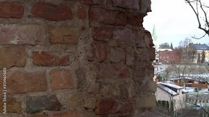 A close-up view of the brick and stone wall structure of the castle ruins. Medieval century historical heritage in territory of Latvia, Zemgale region. The Dobele old town landscape on the hill.