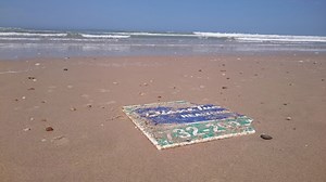 Sign swept away by Superstorm Sandy washes up on French beach