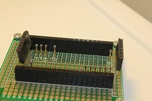 Use extra-long headers to hold a board on a pogo pins testing jig