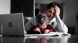 young father works at a computer at home with a child Stock Video