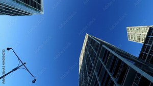 Panning Directly Below View Of Tall Residential Buildings Under Clear Sky In City - Miami, Florida