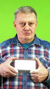 Mature man gives sos signal Morse code using flashlight that he holds in hands.