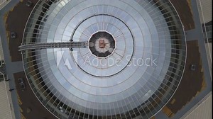 Top-down spiral shot of the Reykjavík Perlan Museum with large water tanks