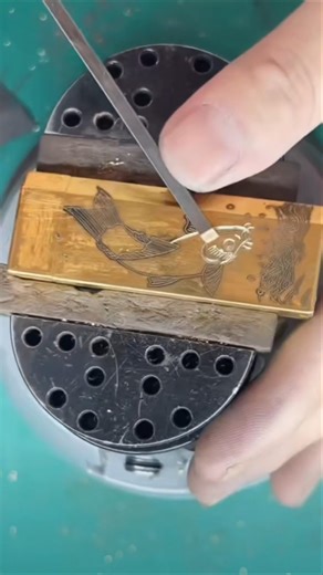 Watch a beautiful fish design being hand-engraved on copper with amazing detail.
