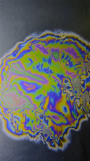 @liquid_tapestry on Instagram: "Look into the abyss --- Thin-film interference is a colorful optical phenomenon where light waves reflecting off the top and bottom surfaces of a thin layer (like oil on water or a soap bubble) interfere, creating bright or dark patterns by constructively or destructively combining at different wavelengths. This interference depends on the film's thickness, the light's wavelength, and phase shifts upon reflection, causing certain colors to appear enhanced or cance