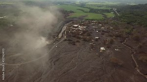 Pivoting aerial view of San Miguel Los Lotes, a small town recently buried in a volcano's (Volcan de Fuego) pyroclastic flow., Guatemala.