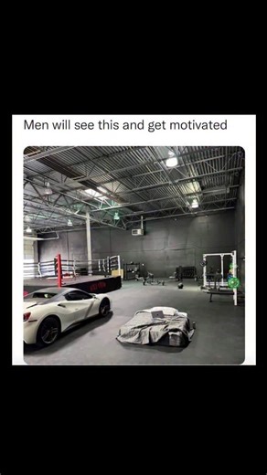 Johnny Bravo Explains Memes on Instagram: "Hey everyone, Johnny here to explain. This meme plays on a common internet trope about minimalist, hyper-focused "grindset" lifestyles that some men idealize. The image shows a huge, mostly empty industrial-style space that serves as a gym—with a boxing ring, weightlifting equipment, and some basic workout gear—but also oddly contains a luxury sports car and a single mattress on the floor with just a laptop and an energy drink. The caption “Men will see