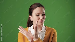 Woman sarcastic applause. Gloomy skeptical woman on chroma key background looking at camera and reluctantly claps her palms to create fake applause. Slow motion