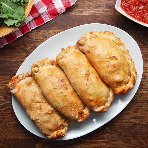Making a calzone from scratch might seem intimidating but this meat lover's calzone recipe makes it easy. Have fun kneading the dough, rolling it out, and stuffing it with a delicious sausage filling. If you aren't sharing these, freeze them and reheat later for a quick lunch or dinner. View & shop these recipes in our app with Walmart Grocery: https://tsty.it/h78O1gfqUab | Tasty