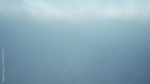 Climbing up through and above the clouds. Revealing the view above the thick clouds, by drone in 4k, 30fps. Peaceful evening sky above layers of clouds, in the English countryside.