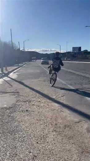 Cyclist on Wheelie Gets Clipped by Oncoming Car