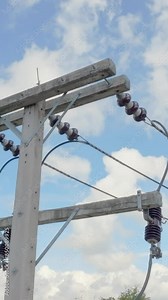 High voltage ceramic insulators on a electricity post in southeast asian. Vertical video. Stock Video