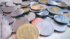 Close-up of a pile of Thai 1 baht silver coins, 2 baht silver coins, 5 baht silver coins, 10 baht silver coins, high resolution background image.