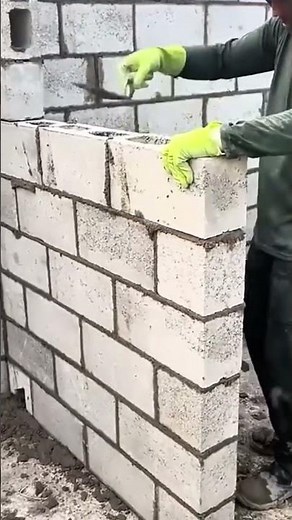 Placing lightweight concrete blocks to build a corner wall