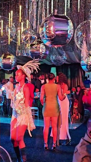 Model dancing with MC at an event. Who won?