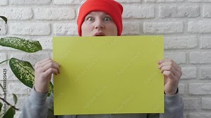 The man nods his head saying yes, a strange head nodding yes, a man with a blank sheet for typing, a young guy with a stick of copy space