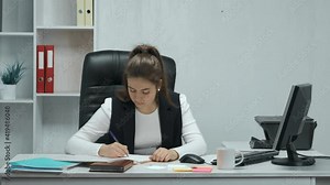 An office worker performs work on a computer. A businesswoman does an important job. Everyday life of an office worker. The concept of working in the office.
