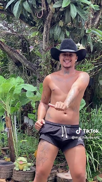 Shirtless Cowboy Hat Dance in Tropical Setting