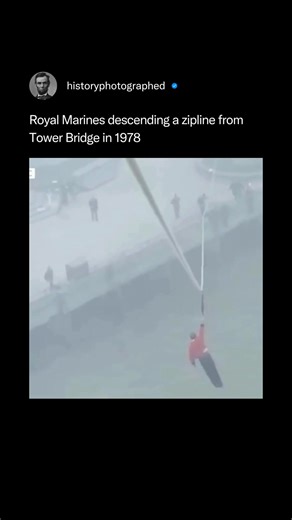 In 1978, a team of Royal Marines from 45 Commando executed a spectacular "death slide" (zipline descent) from the top of London's Tower Bridge as a public demonstration of their cliff-assault techniques. The 150-meter descent was featured on the BBC children's program Blue Peter, with presenter Simon Groom also participating in the daring stunt. This memorable event showcased the Marines' skills and provided one of the most iconic moments in the television show's history. Credit: @bbc_archive | 
