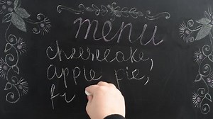 We write the menu on a board. The menu with desserts and drinks.