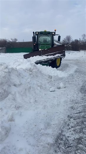 John Deere Tractor Snow Plowing in Rural Landscape